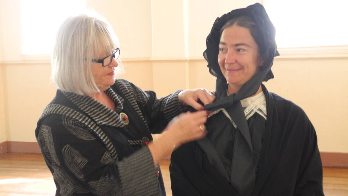 Lyn Catt helps Kath Palmer (Isabella) with her costume.