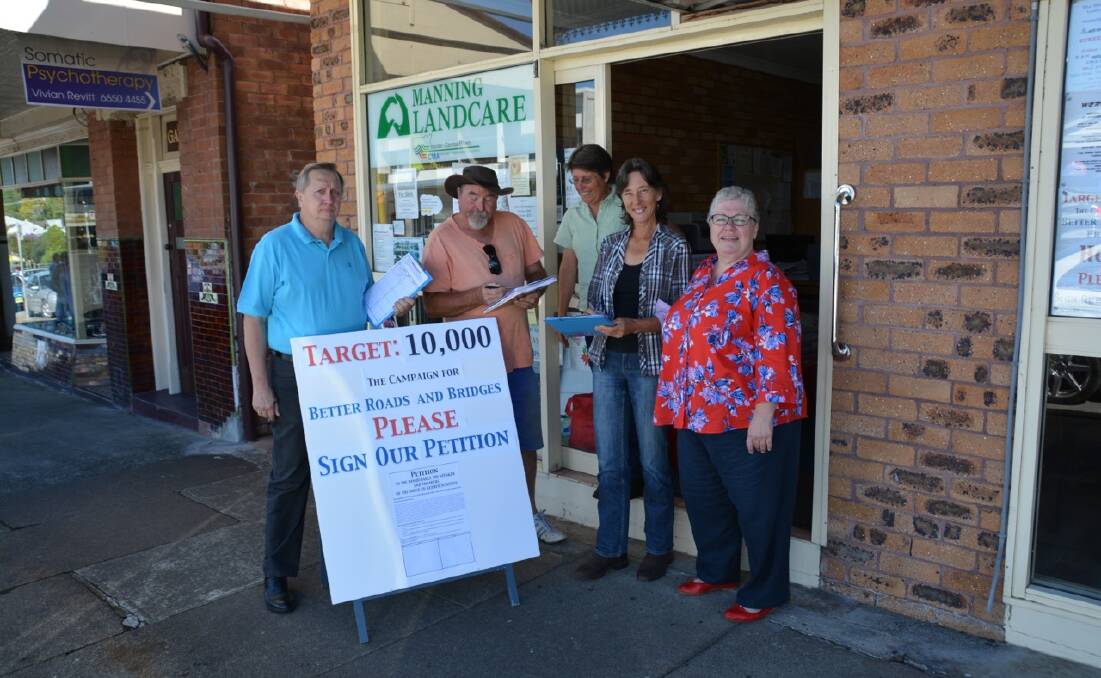 Cr Epov with Landcare's Lyn Booth, Alison Allan and deputy mayor Robyn Jenkins as a member of the community signs the Target 10,000 petition for better roads and bridges in the Manning Valley.