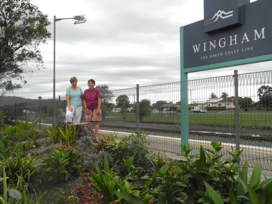 Liz Cross and Lyn McKinlay with the remains of one of the Jacaranda trees at Wingham  Railway Station