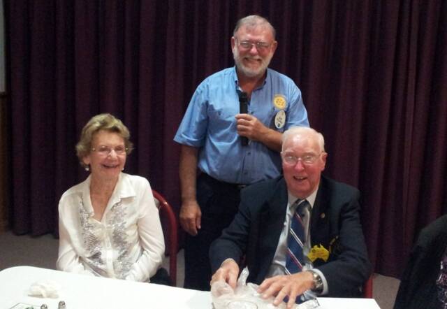 Bill Freman with wife Merlin (Merle) with Wingham Rotary president Dave Sullings (standing) at a special evening to honour Bill's contribution to Rotary.