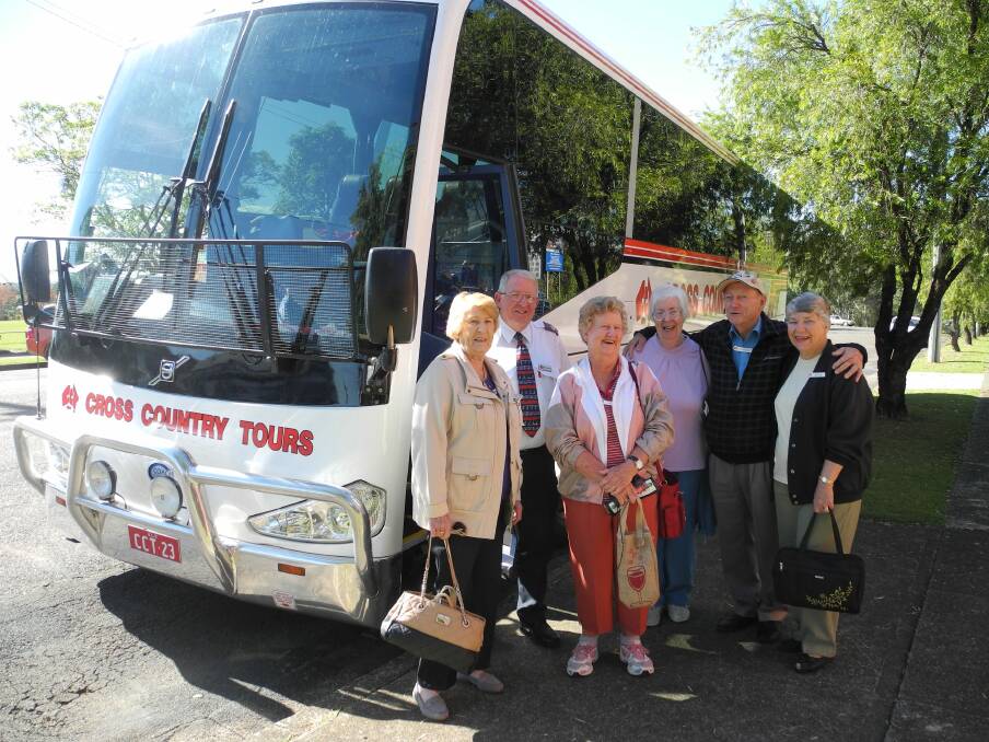 Enjoying Wingham are Queensland tourists Hazel Cook and Dawn Hood (front row) with bus driver Neil Carmichael, Jan Jones and Fred and Joyce McMillan.