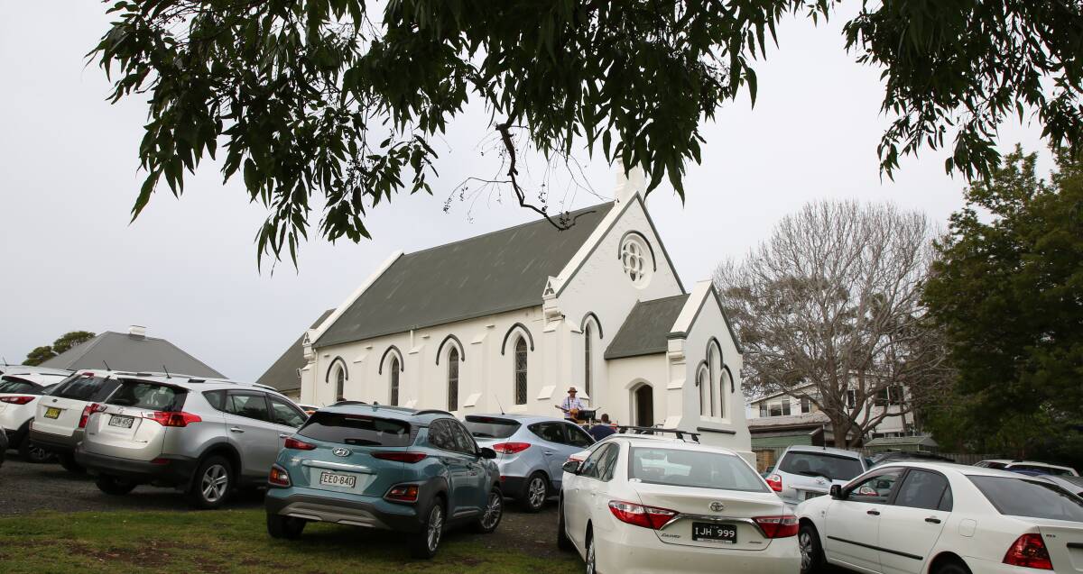 Church with a difference: Rev Peter Campbell leading a drive-in service on Sunday outside Gerringong Uniting Church. Picture: Greg Ellis