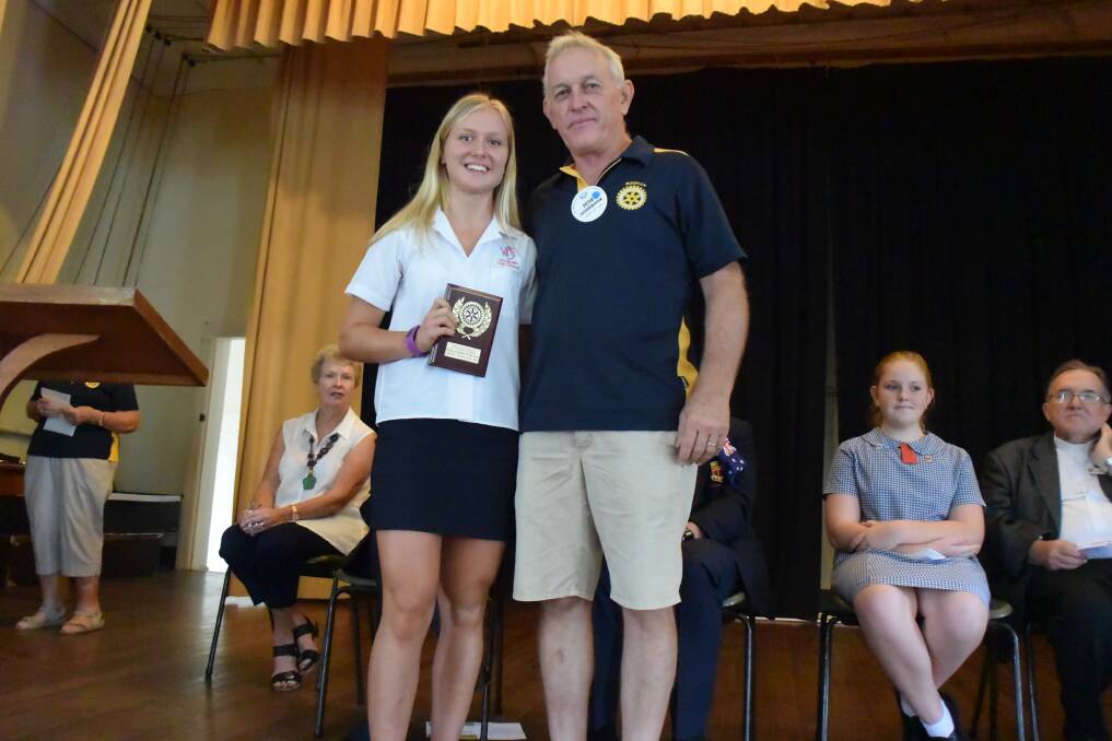 Youth of the Year Jamie Hemmingway accepts her award from Wingham Rotary Club president Peter Fotheringham.