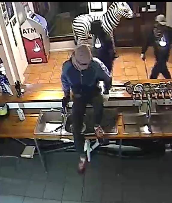 A CCTV image from an armed robbery at Wauchope. 