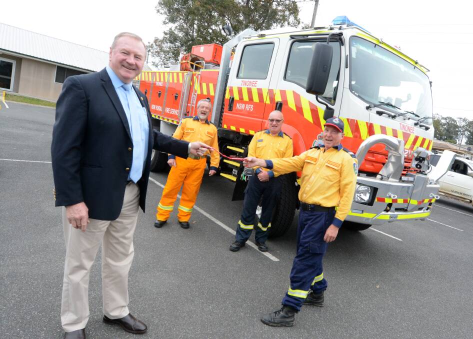 Member for Myall Lakes Stephen Bromhead hands the keys over to Tinonee RFS acting captain Bruce Annetts. They are pictured with Tinonee president Alan Steber and Mid Coast RFS district manager Kam Baker. Photo: Scott Calvin.