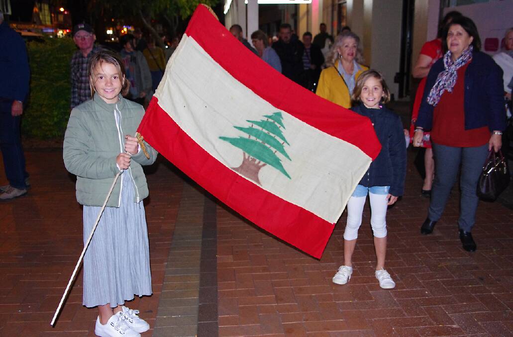 Lily and Jessica Richardson holding the Lebanese flag during the tour. Photo: Peter Langdown.