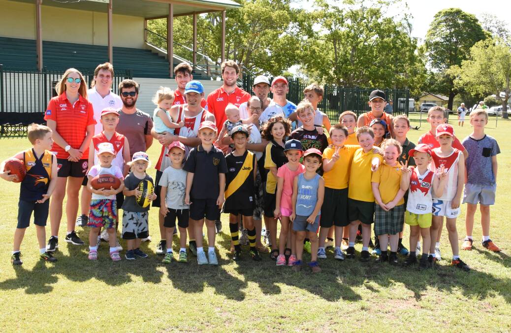 The Swans hanging out with local Aussie Rules players in 2018. The club will visit Taree West Public School and Manning Valley Mustangs players next Wednesday. 
