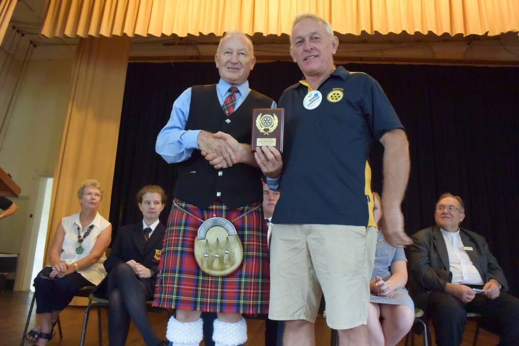 Pipe Major John Andrews accepts the Pride of Workmanship Award on behalf of the Pipes and Drums Band from Wingham Rotary Club president Peter Fotheringham. 