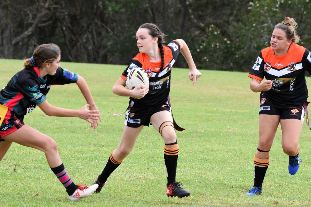 Wingham's Paris Faugeras evades a Taree Panthers player during the Group Three Junior Rugby League's girl's league tag gala day earlier this year.