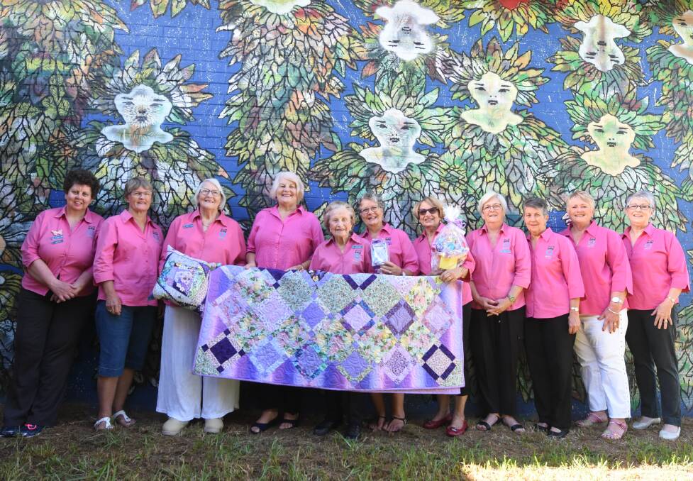 Shades of purple: Taree Quota Club members display the raffle prizes, ahead of a fashion parade at Manning Regional Art Gallery. Photo: Scott Calvin.