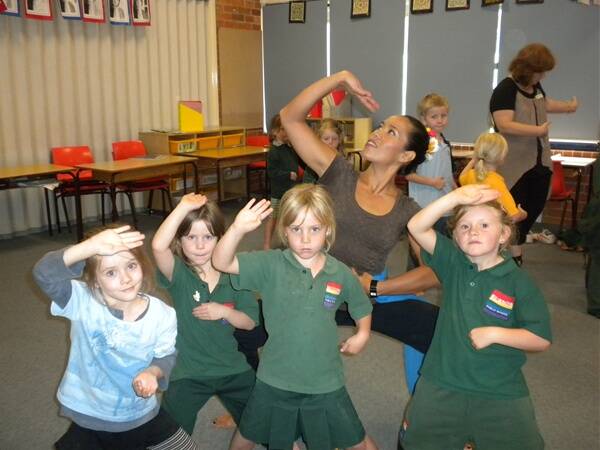 oe Hatton from Bobin Public School and Jasmine Booth, Bree Hosemans and Hannah Donolato from Elands Public School learning Indonesian style dancing from teacher Jade Dewi. 